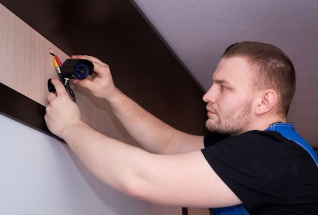 Adam from Humber Alarms installing a security system